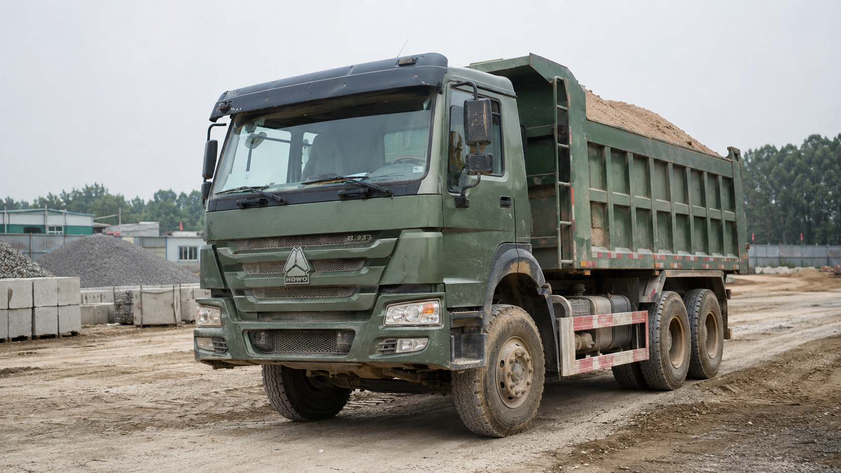 6x4 dump truck transporting sand on a construction site