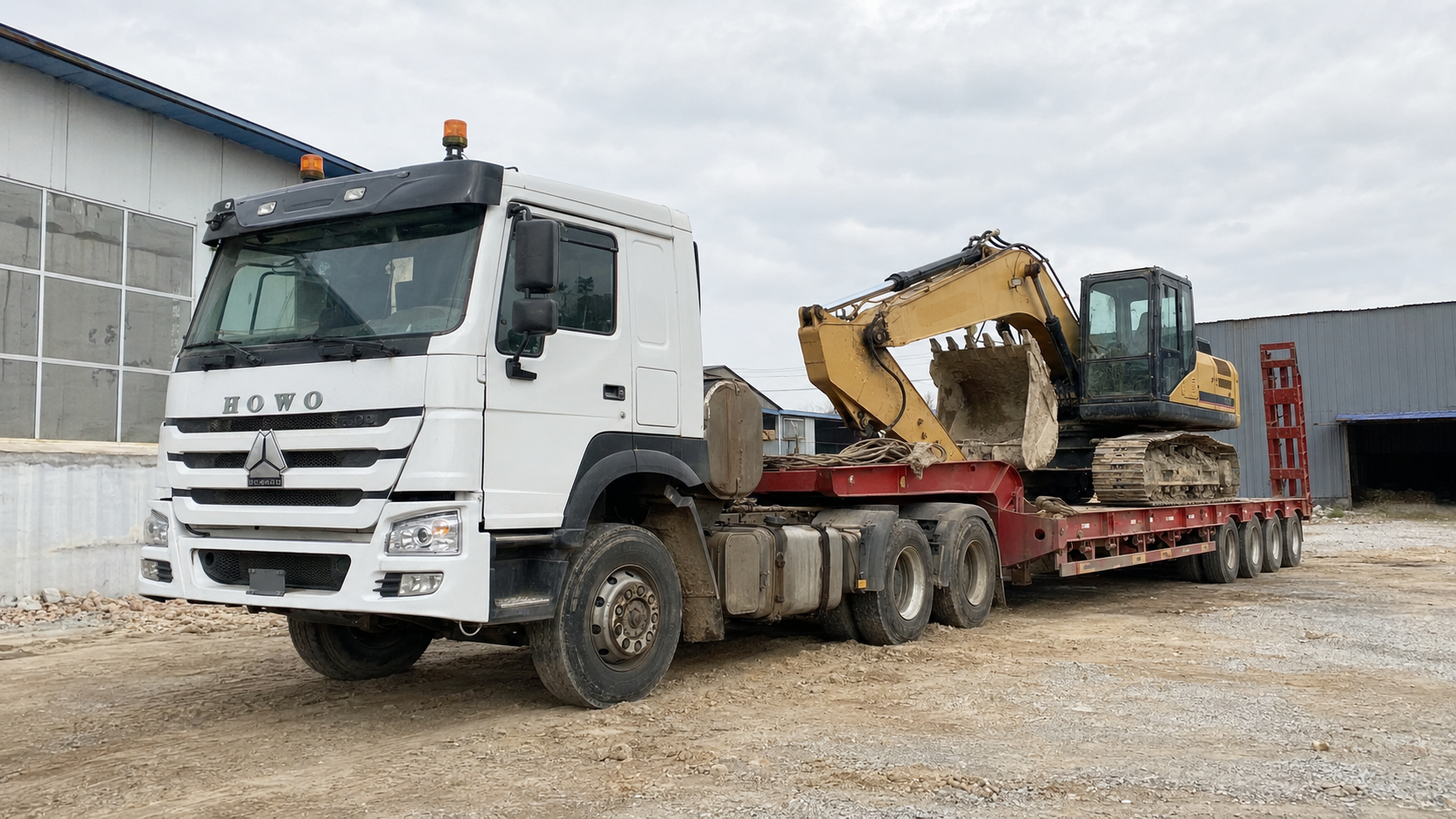 Low bed semi trailer transporting an excavator