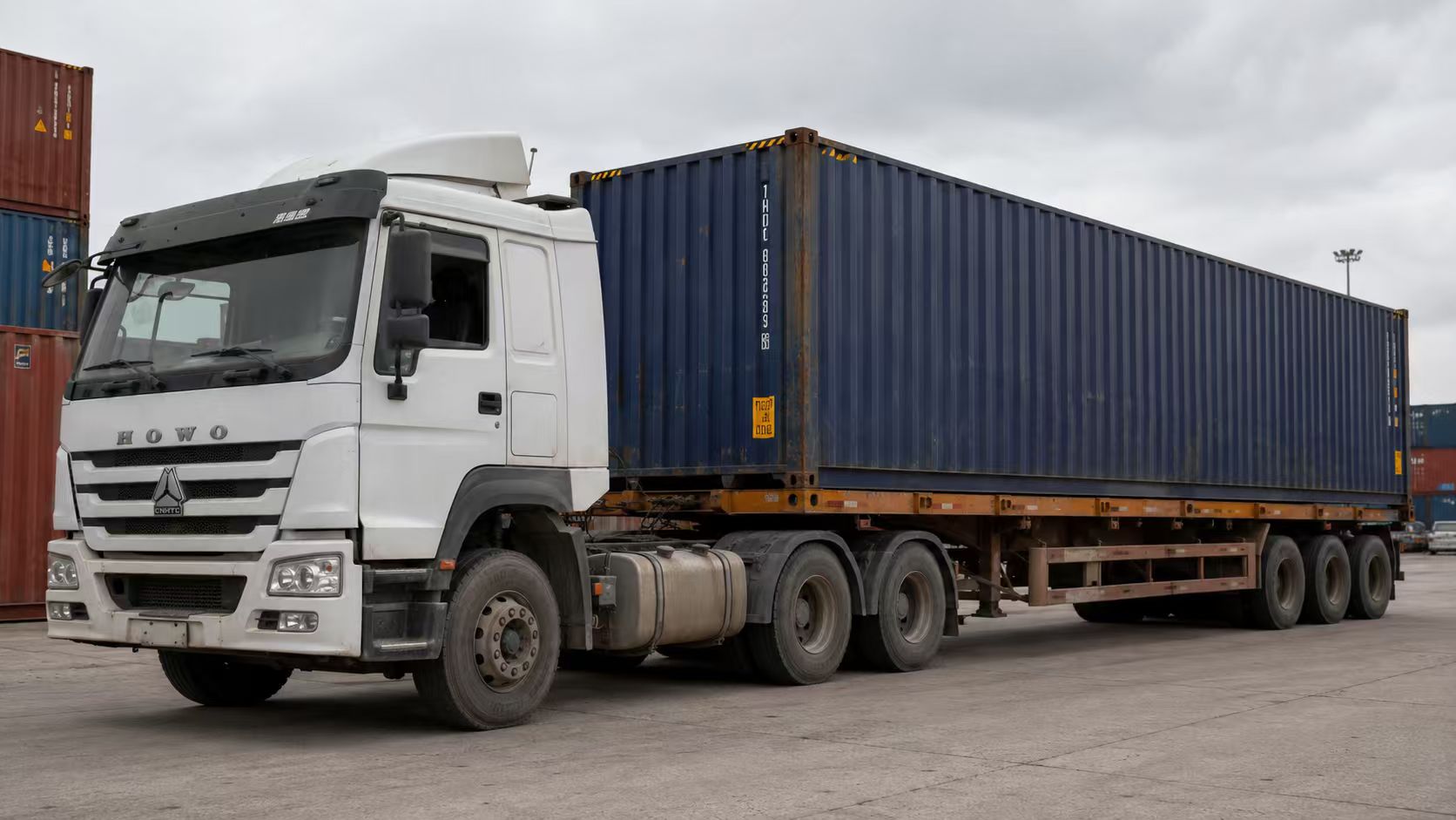 HOWO tractor truck pulling a container semi trailer