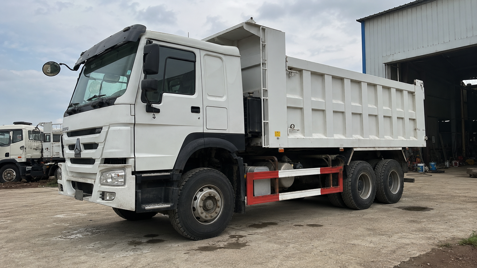 White used dump truck prepared in a truck yard