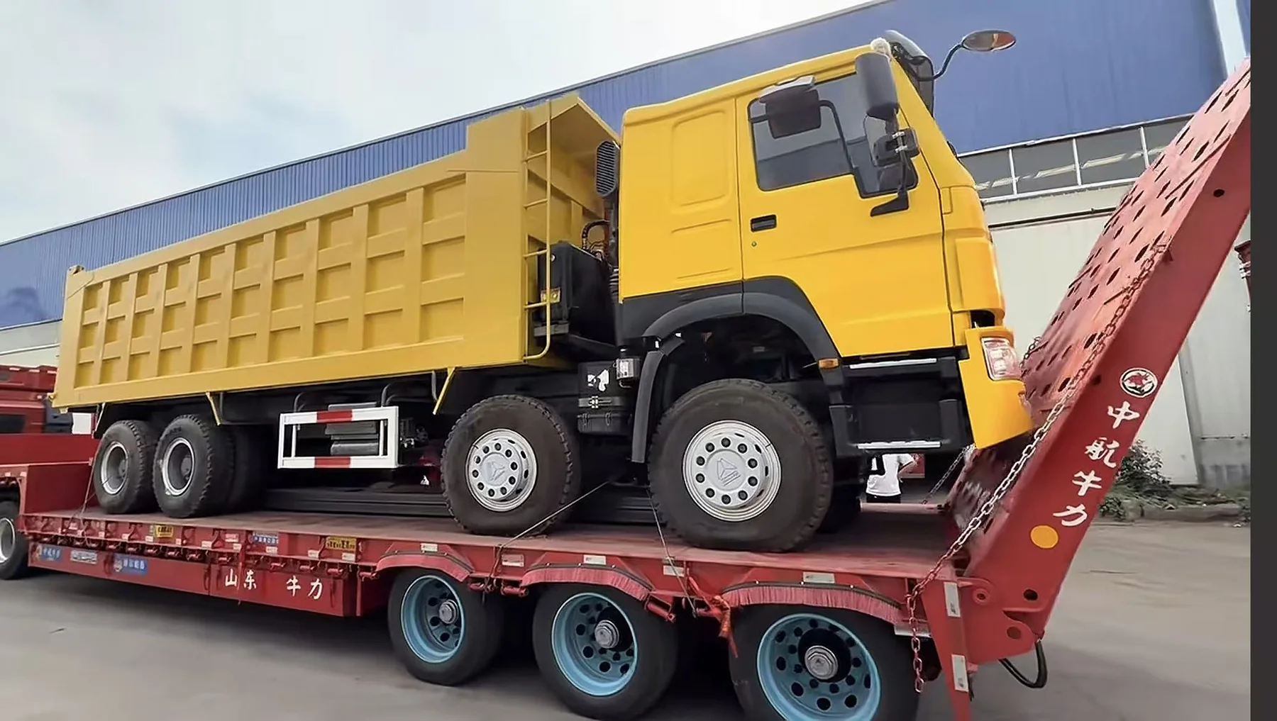 Yellow dump truck prepared for shipment