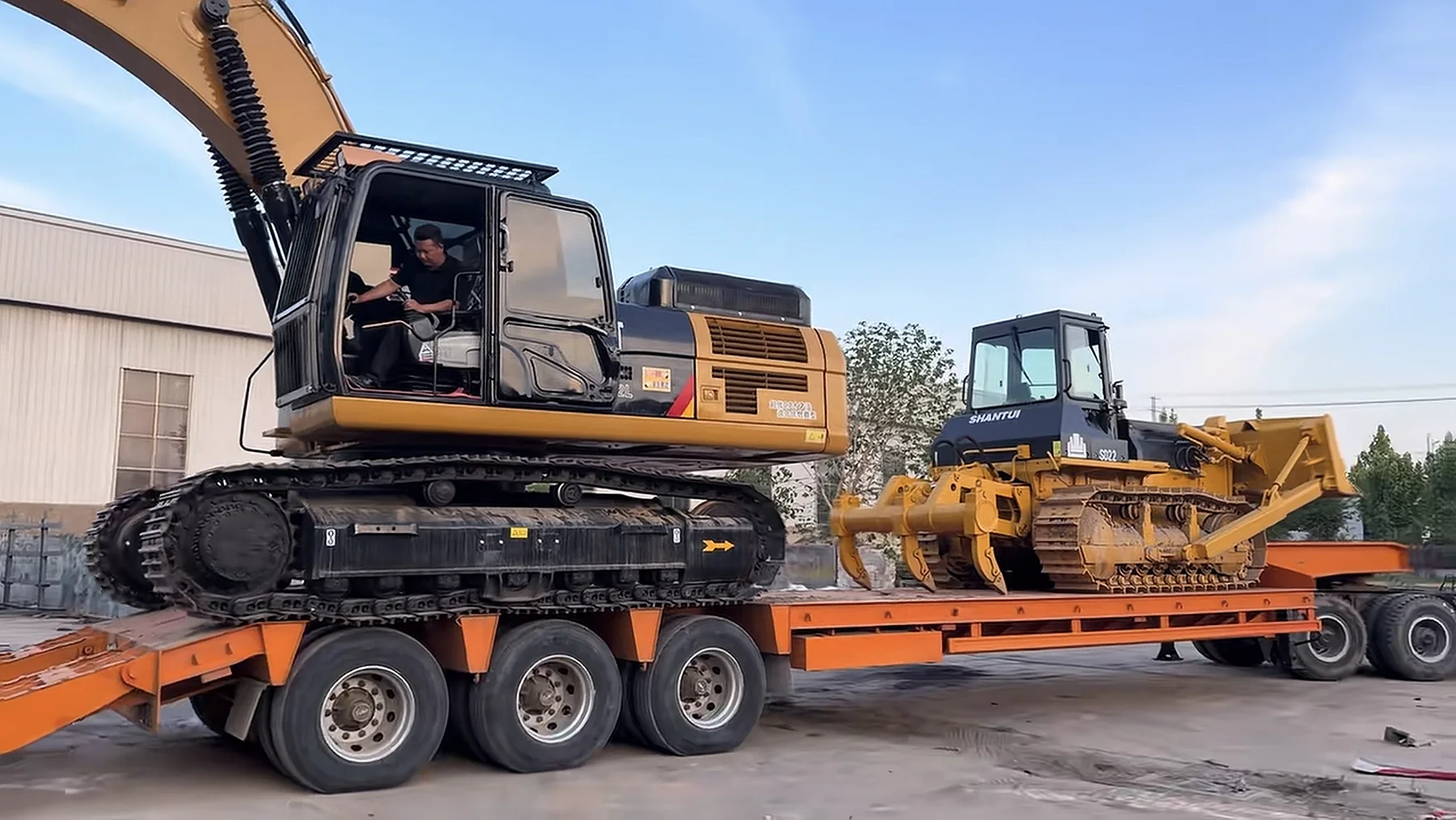 Excavator and bulldozer loaded on a lowbed trailer