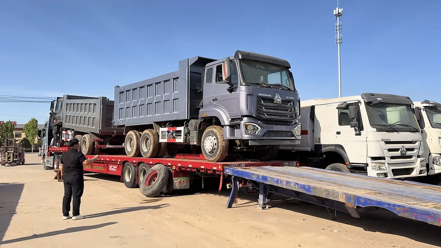 Dump trucks loaded for delivery from the yard